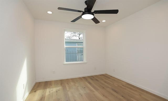 spare room with ceiling fan and light hardwood / wood-style floors