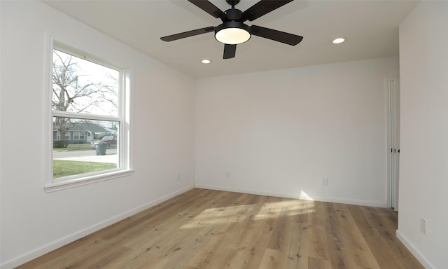 unfurnished room with ceiling fan and light wood-type flooring