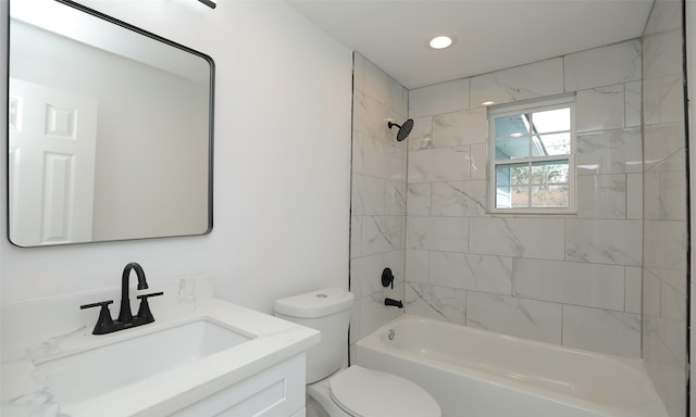 full bathroom with tiled shower / bath combo, toilet, and vanity