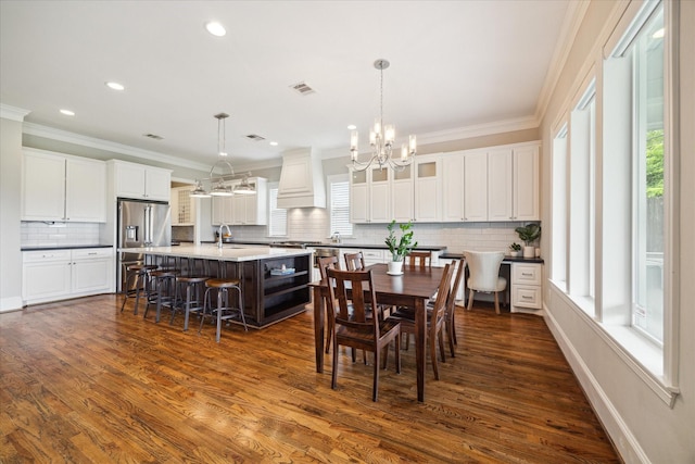 dining room with a wealth of natural light, dark wood-type flooring, and sink