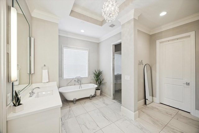 bathroom featuring a washtub, vanity, crown molding, and a notable chandelier