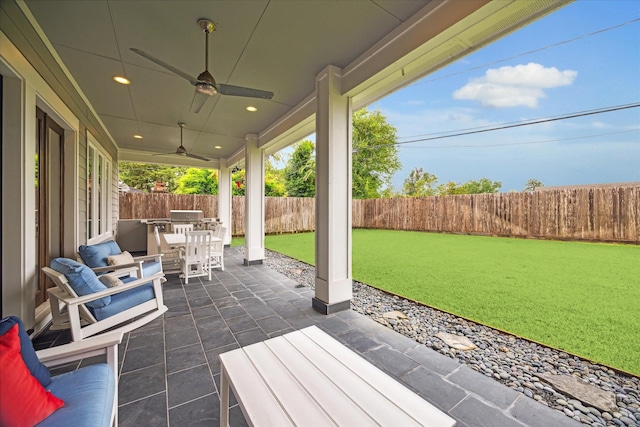 view of patio with ceiling fan and an outdoor kitchen