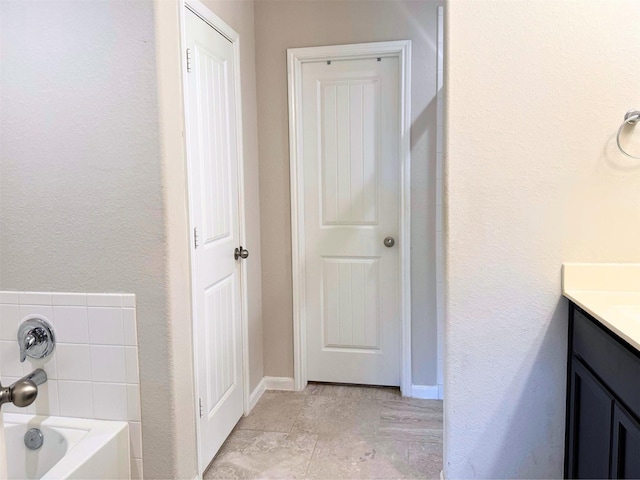 full bathroom with a bathtub and vanity