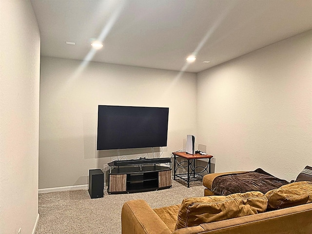 carpeted living area featuring baseboards and recessed lighting