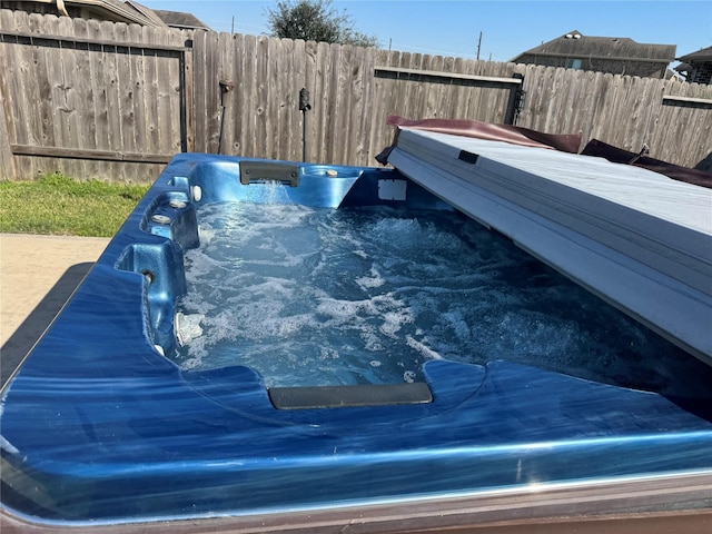 exterior space with fence and a hot tub