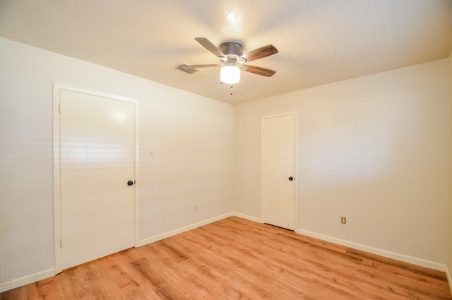 empty room with ceiling fan and light wood-type flooring