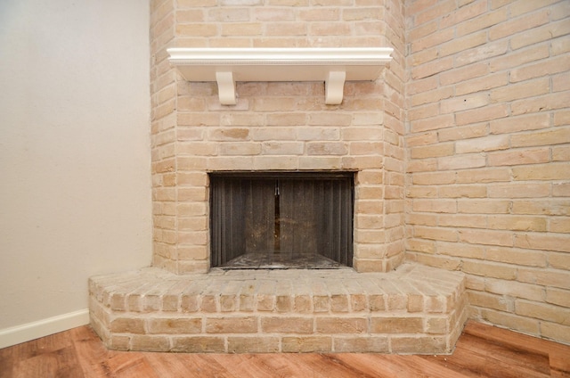 interior details featuring hardwood / wood-style flooring and a fireplace