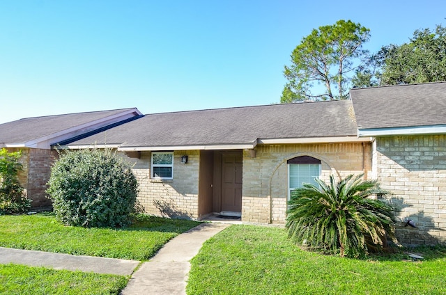 ranch-style home featuring a front yard