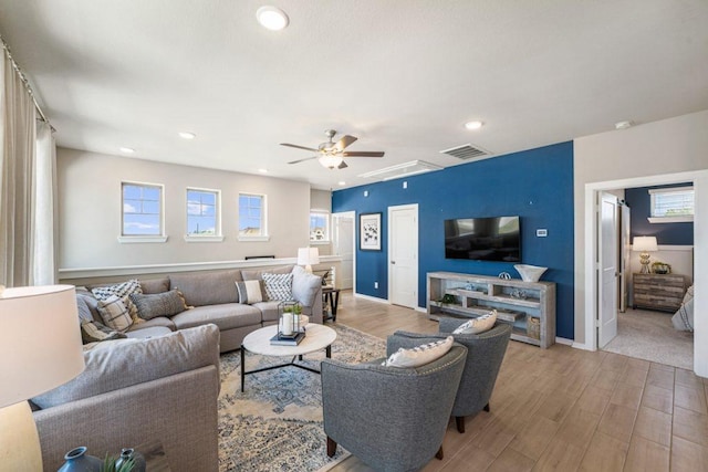 living room featuring light hardwood / wood-style floors and ceiling fan