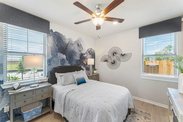 bedroom with light hardwood / wood-style flooring and ceiling fan