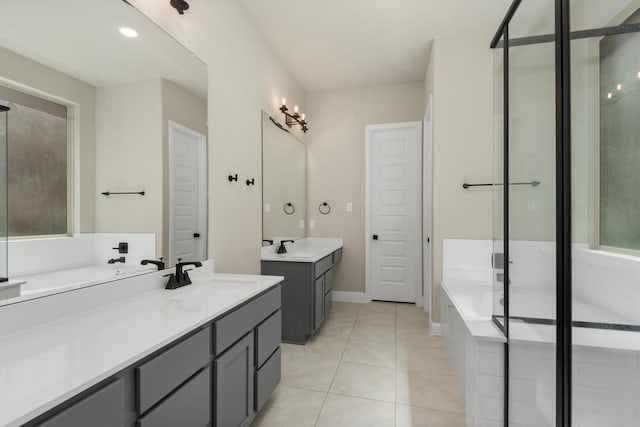 bathroom featuring tile patterned flooring, shower with separate bathtub, and vanity