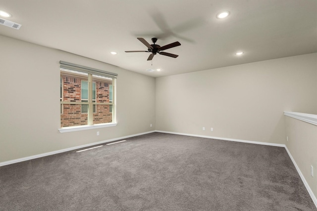 carpeted spare room featuring ceiling fan