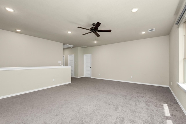 empty room featuring carpet floors and ceiling fan