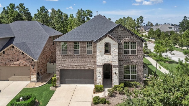 view of front of property with a garage and a front lawn