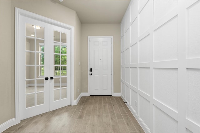 doorway to outside featuring french doors and light hardwood / wood-style floors