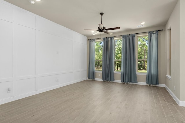 empty room featuring ceiling fan and light hardwood / wood-style flooring