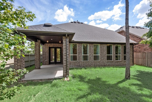 rear view of house featuring a yard and a patio