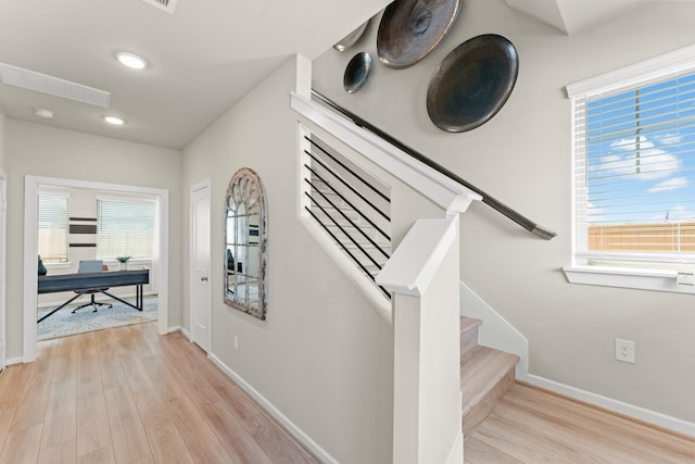 stairway featuring wood-type flooring