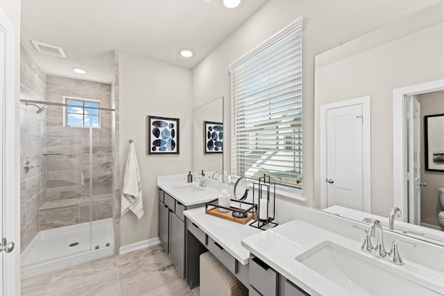 bathroom with vanity, toilet, an enclosed shower, and a healthy amount of sunlight