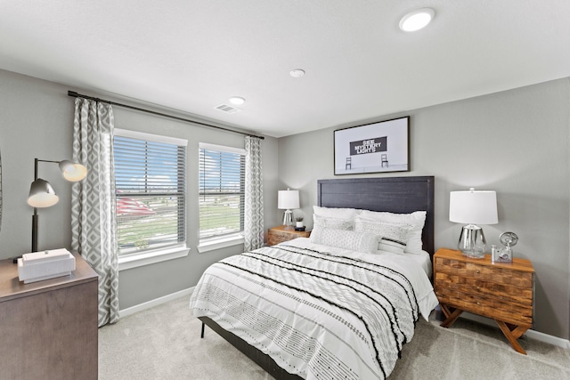 bedroom featuring light carpet