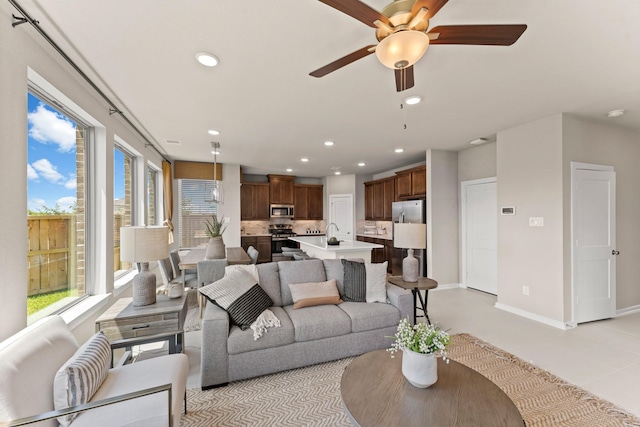 living room with ceiling fan and sink