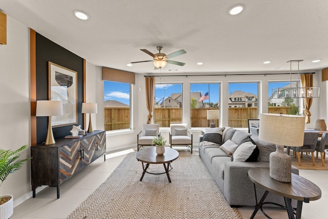 living room featuring light tile patterned floors and ceiling fan