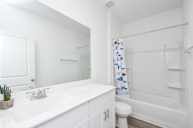 full bathroom with hardwood / wood-style floors, vanity, toilet, and shower / tub combo with curtain