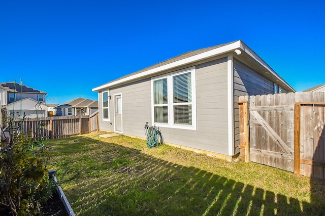 rear view of house featuring a yard