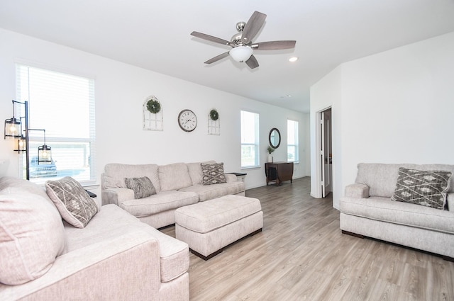 living room featuring light hardwood / wood-style flooring and ceiling fan