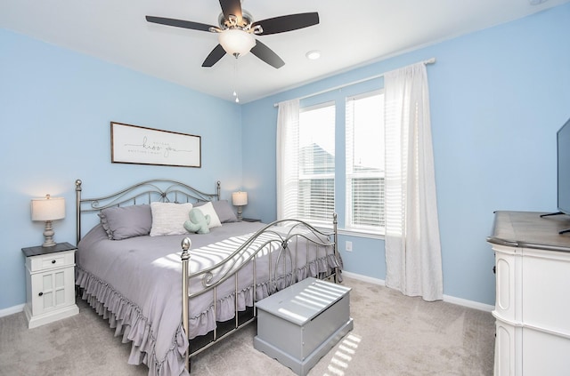 carpeted bedroom with multiple windows and ceiling fan