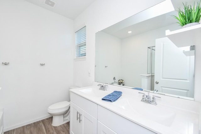 bathroom featuring hardwood / wood-style flooring, vanity, and toilet