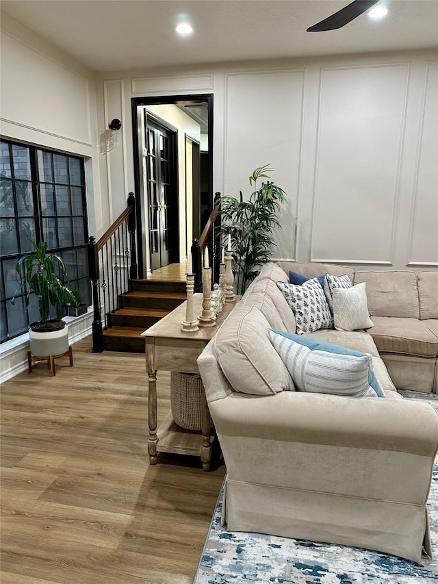 living room with ceiling fan and light hardwood / wood-style flooring