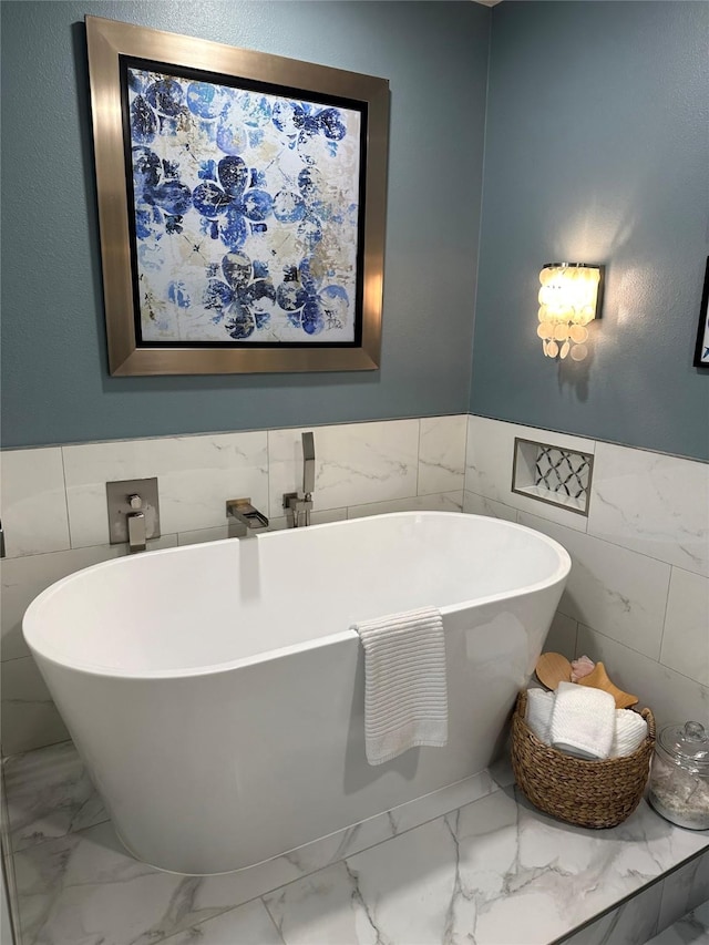 bathroom with a bathtub and tile walls