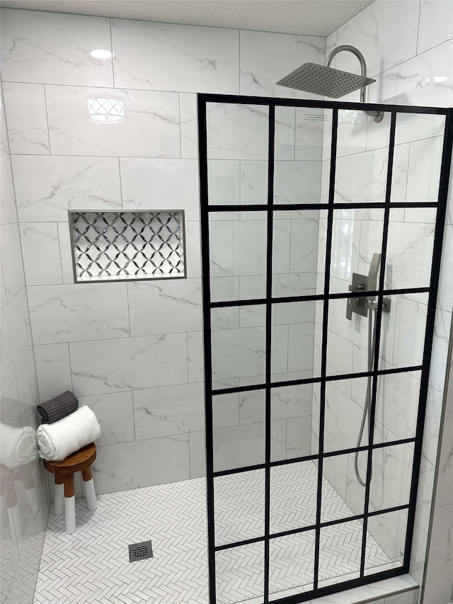 bathroom with tiled shower