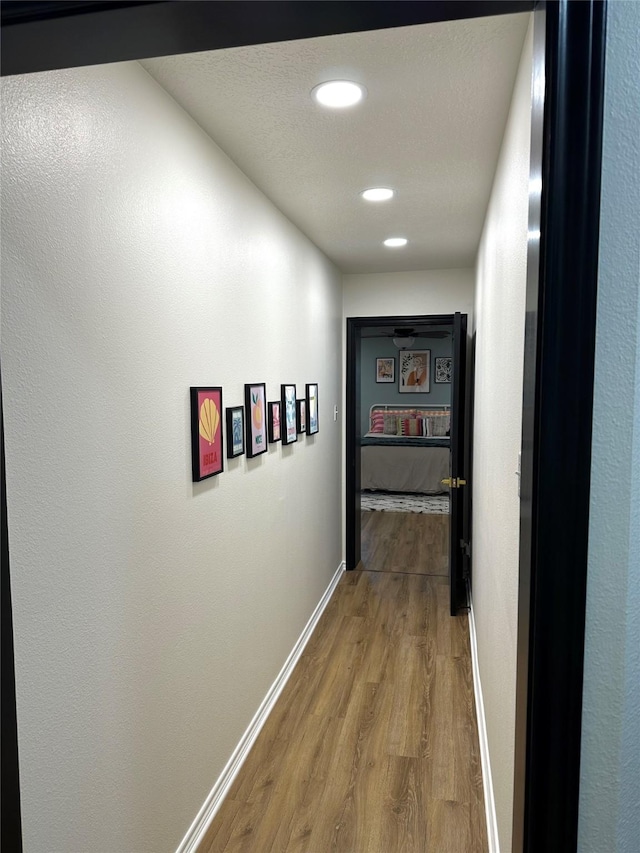 hallway with wood-type flooring