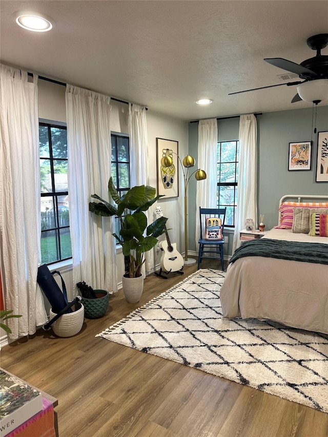 bedroom featuring hardwood / wood-style flooring and ceiling fan