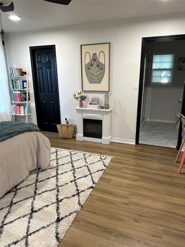 bedroom with wood-type flooring and ensuite bathroom