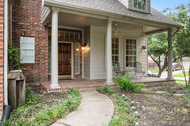 view of exterior entry featuring covered porch and ceiling fan