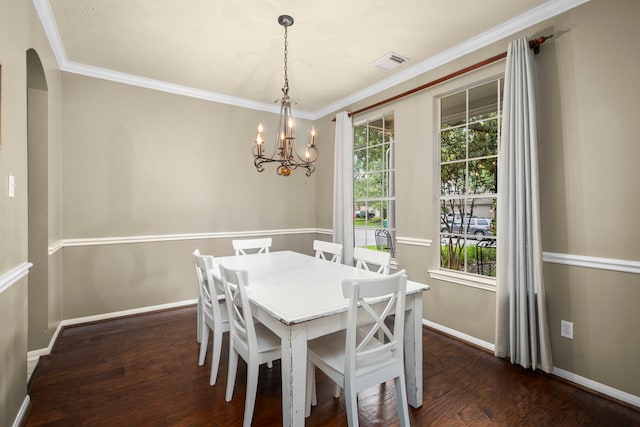 dining area with a notable chandelier, dark hardwood / wood-style flooring, and ornamental molding