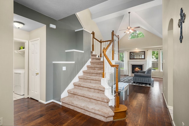 stairs with washer / dryer, ceiling fan, and hardwood / wood-style flooring