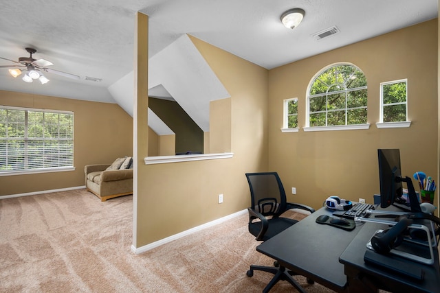 office area featuring light carpet, a wealth of natural light, vaulted ceiling, and ceiling fan