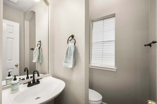 bathroom with toilet and sink