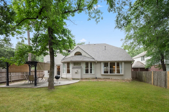 rear view of property with a yard and a patio