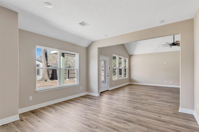 interior space featuring ceiling fan, lofted ceiling, and light wood-type flooring