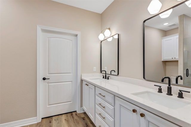 bathroom featuring hardwood / wood-style floors and vanity