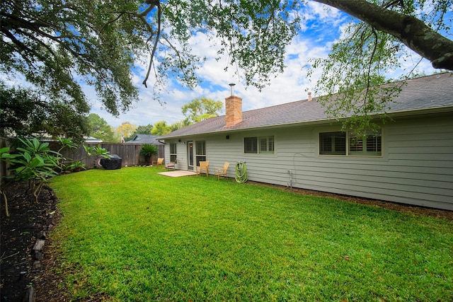 back of property featuring a lawn