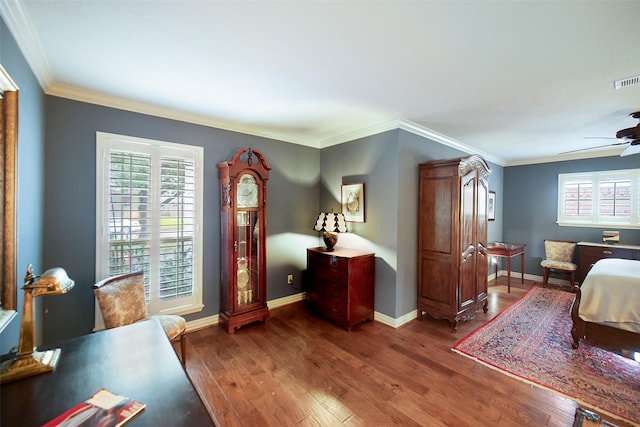 bedroom with hardwood / wood-style floors, ceiling fan, and crown molding