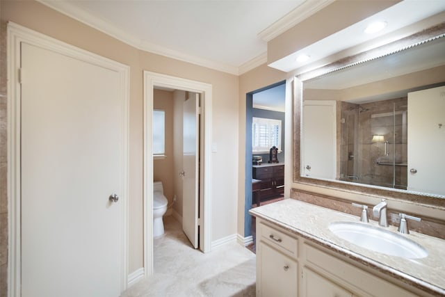 bathroom with vanity, toilet, a shower with door, and crown molding