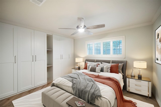 bedroom with crown molding, ceiling fan, and dark wood-type flooring