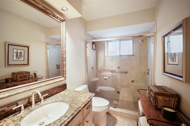 bathroom with tile patterned flooring, vanity, toilet, and a shower with door